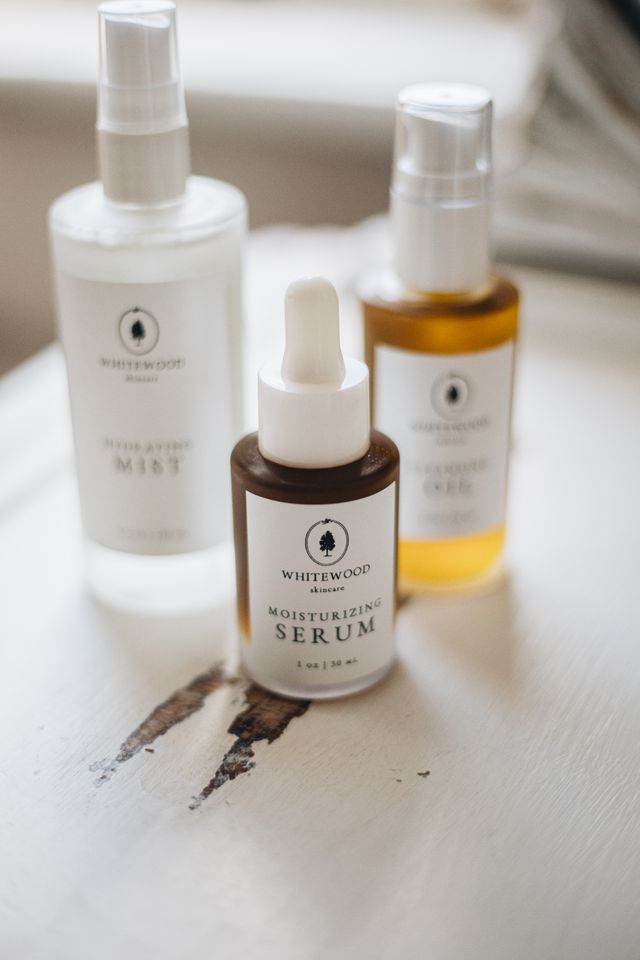 Mist, serum and face oil bottles on a white table