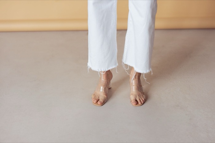 Cropped white jeans with clear-strap sandals