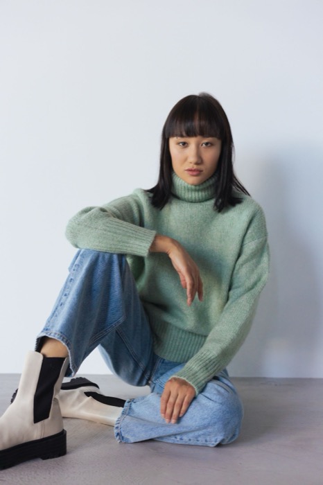 Sage roll-neck jumper with blue jeans and cream boots